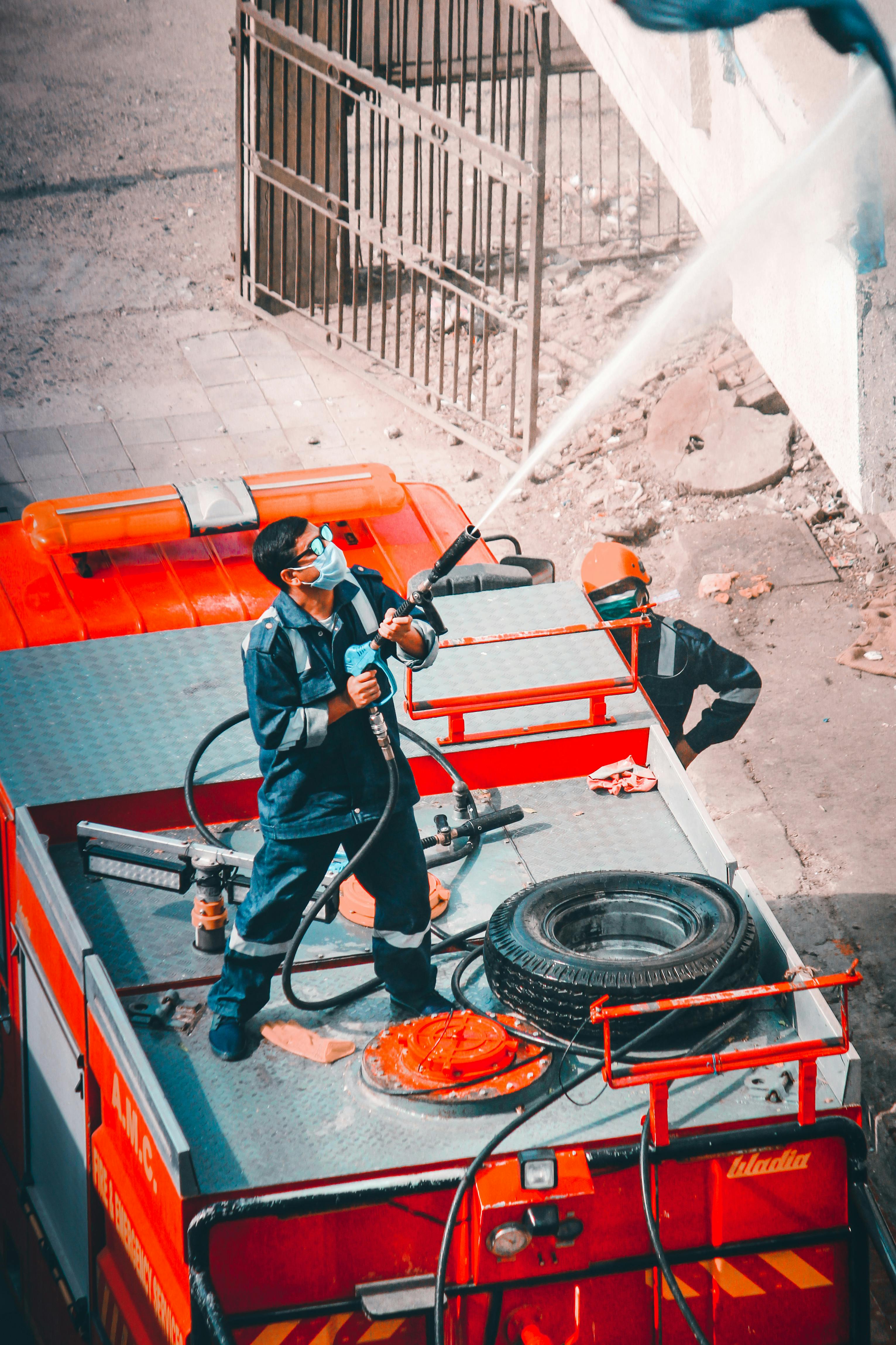 Emergency response workers operating equipment on a service vehicle — the frontline operating in real time.