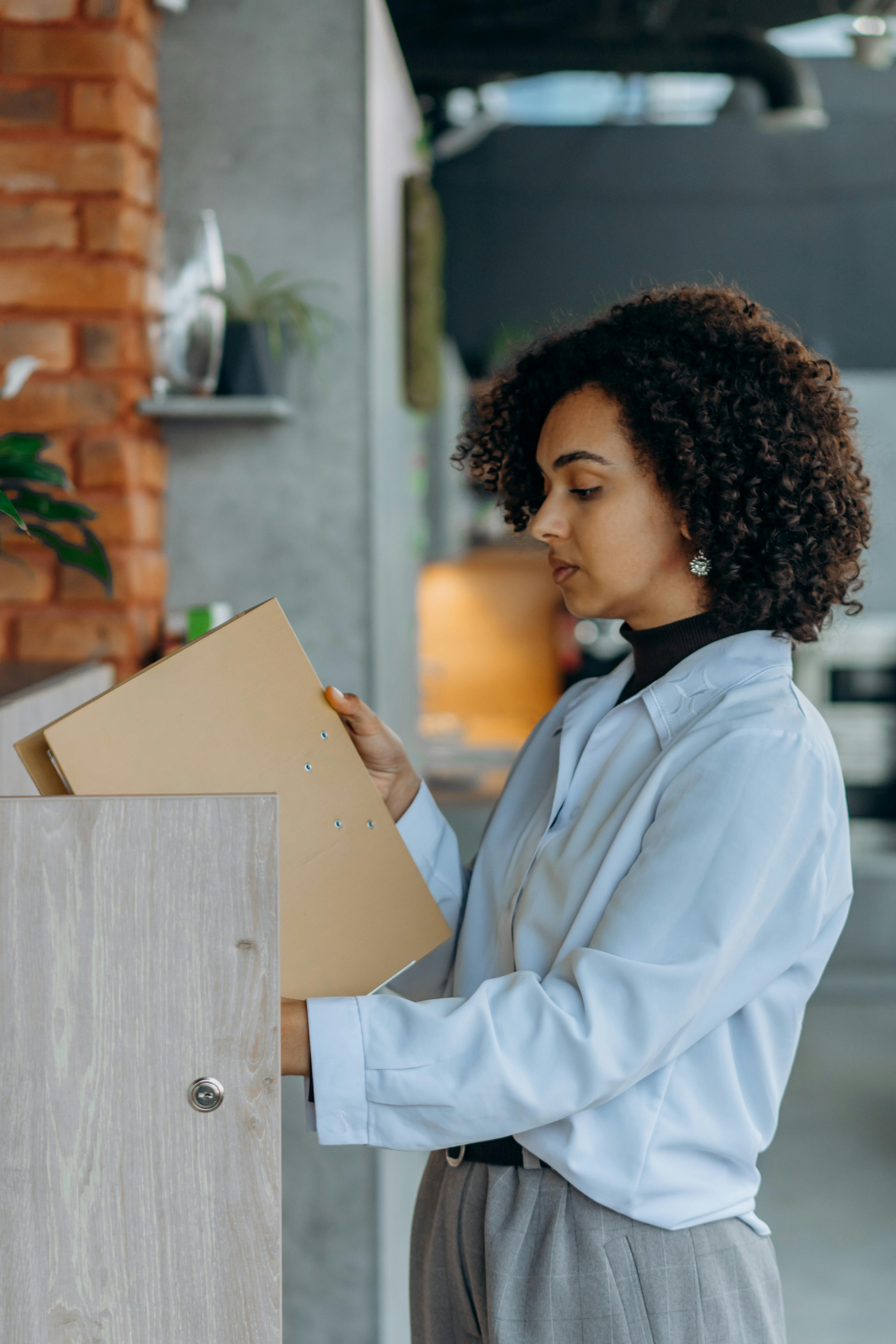 A consultant in a modern office holding portfolio binders — the partner ecosystem that takes RedeApp into the enterprise.